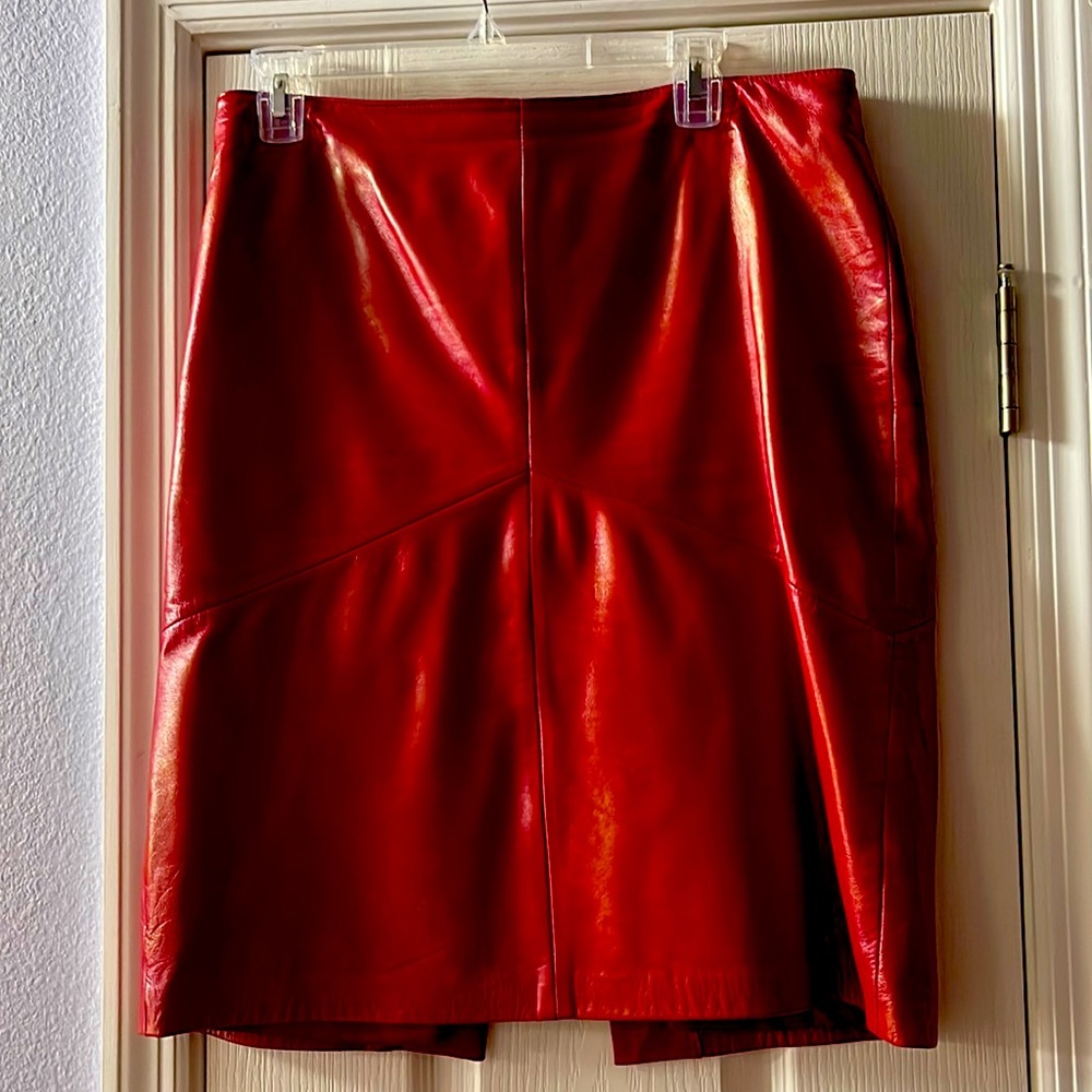 Ladies red leather skirt with seam detail in front and back. Full cut.